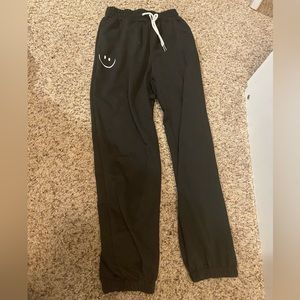 Black smiley face sweat pants
